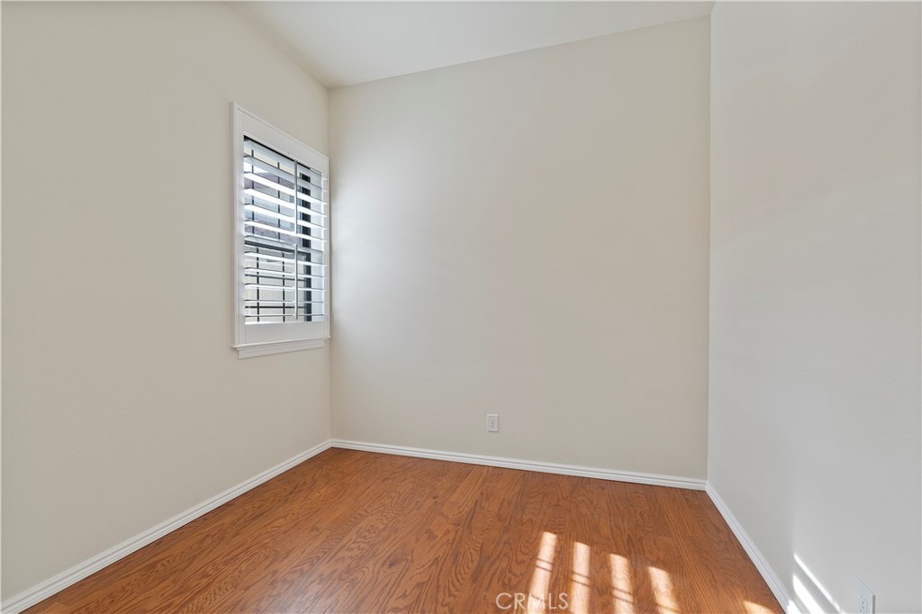 37420 Leta Drive Calimesa, CA 92320 - Photo 16 of 24 a view of an empty room with wooden floor and a window