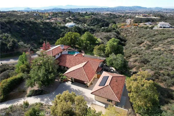 an aerial view of a house with a yard