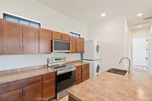 a kitchen with a sink a stove and a refrigerator