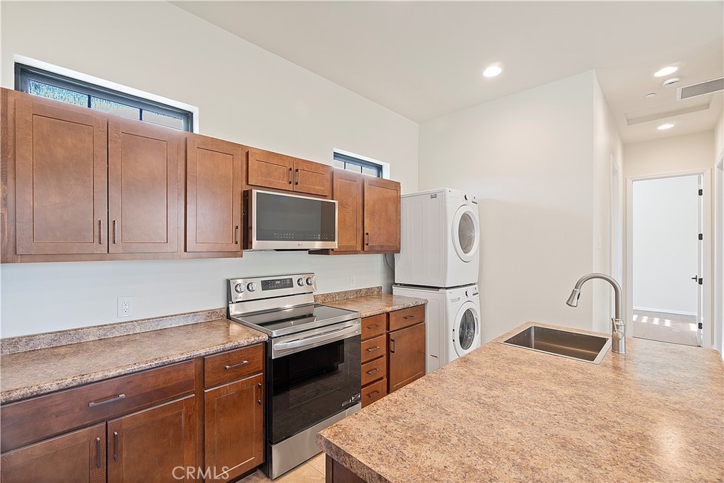 37420 Leta Drive Calimesa, CA 92320 - Photo 9 of 24 a kitchen with a sink a stove and a refrigerator