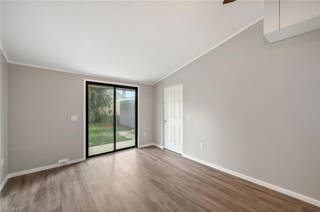 17568 Lee Road Fort Myers, FL 33967 - Photo 11 of 22 a view of an empty room with wooden floor and a window