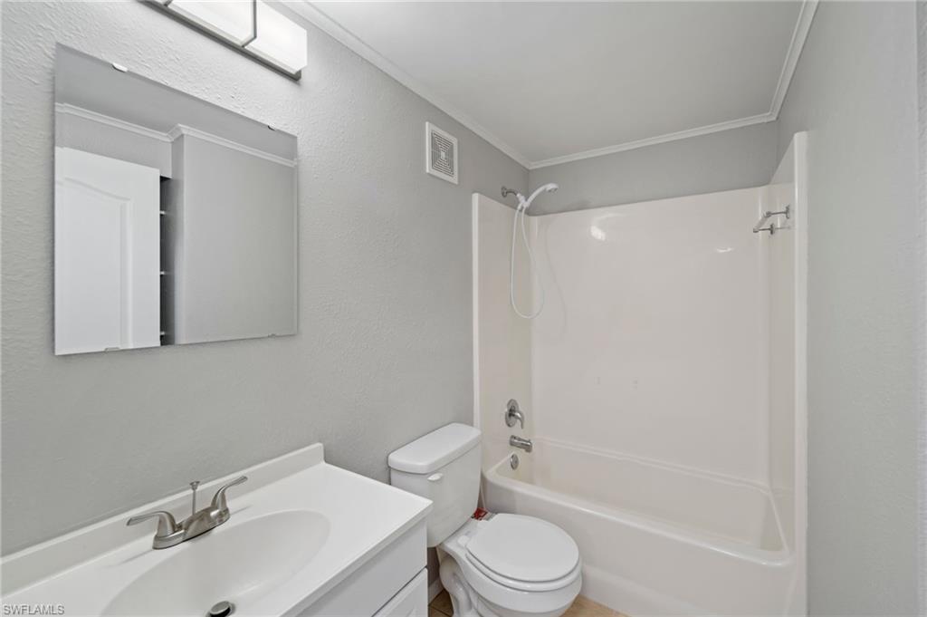 17568 Lee Road Fort Myers, FL 33967 - Photo 13 of 22 a bathroom with a sink toilet and shower