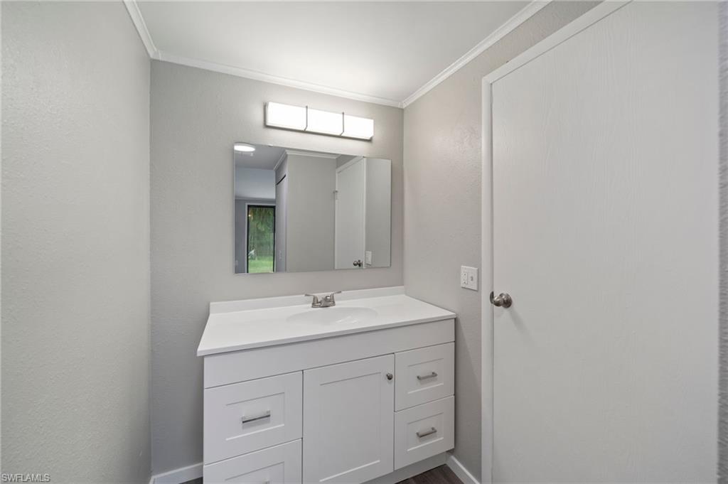 17568 Lee Road Fort Myers, FL 33967 - Photo 18 of 22 a bathroom with a sink and a mirror
