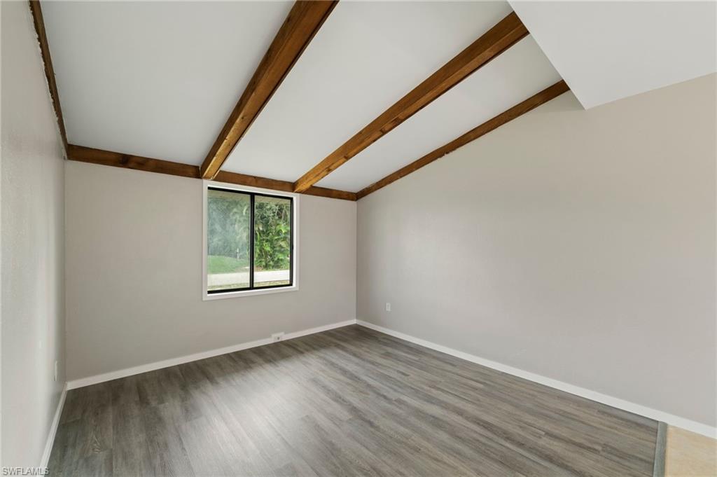 17568 Lee Road Fort Myers, FL 33967 - Photo 6 of 22 a view of an empty room with wooden floor and a window