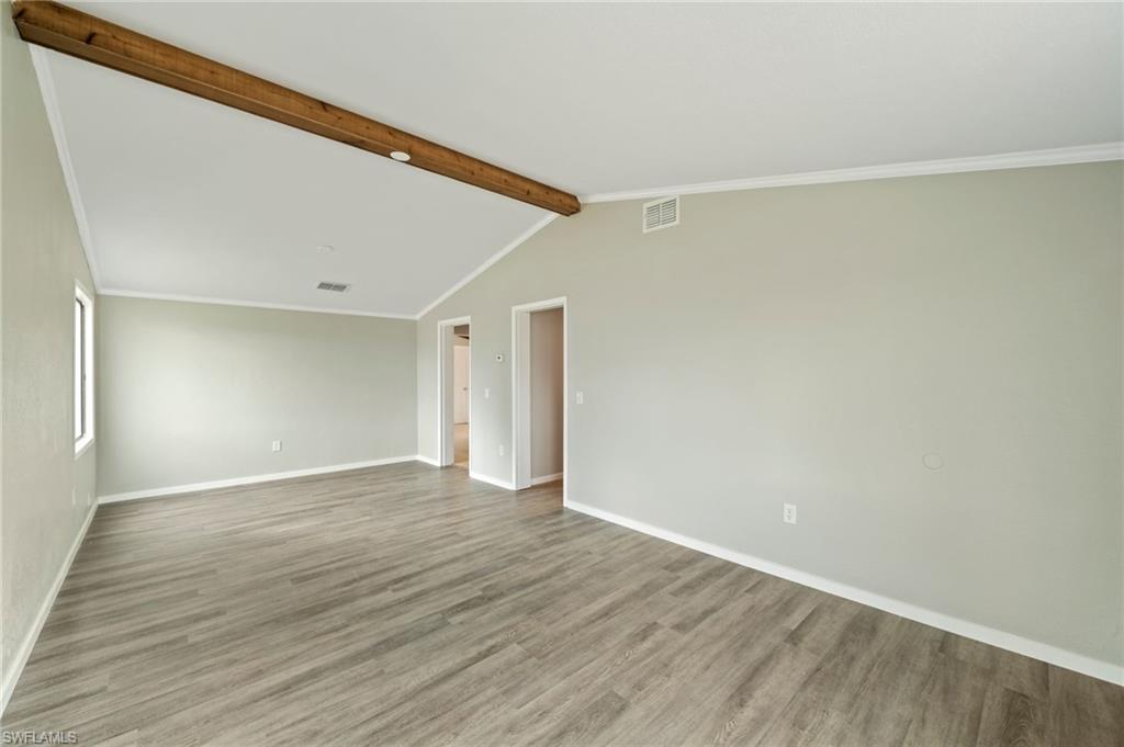 17568 Lee Road Fort Myers, FL 33967 - Photo 8 of 22 a view of an empty room with wooden floor