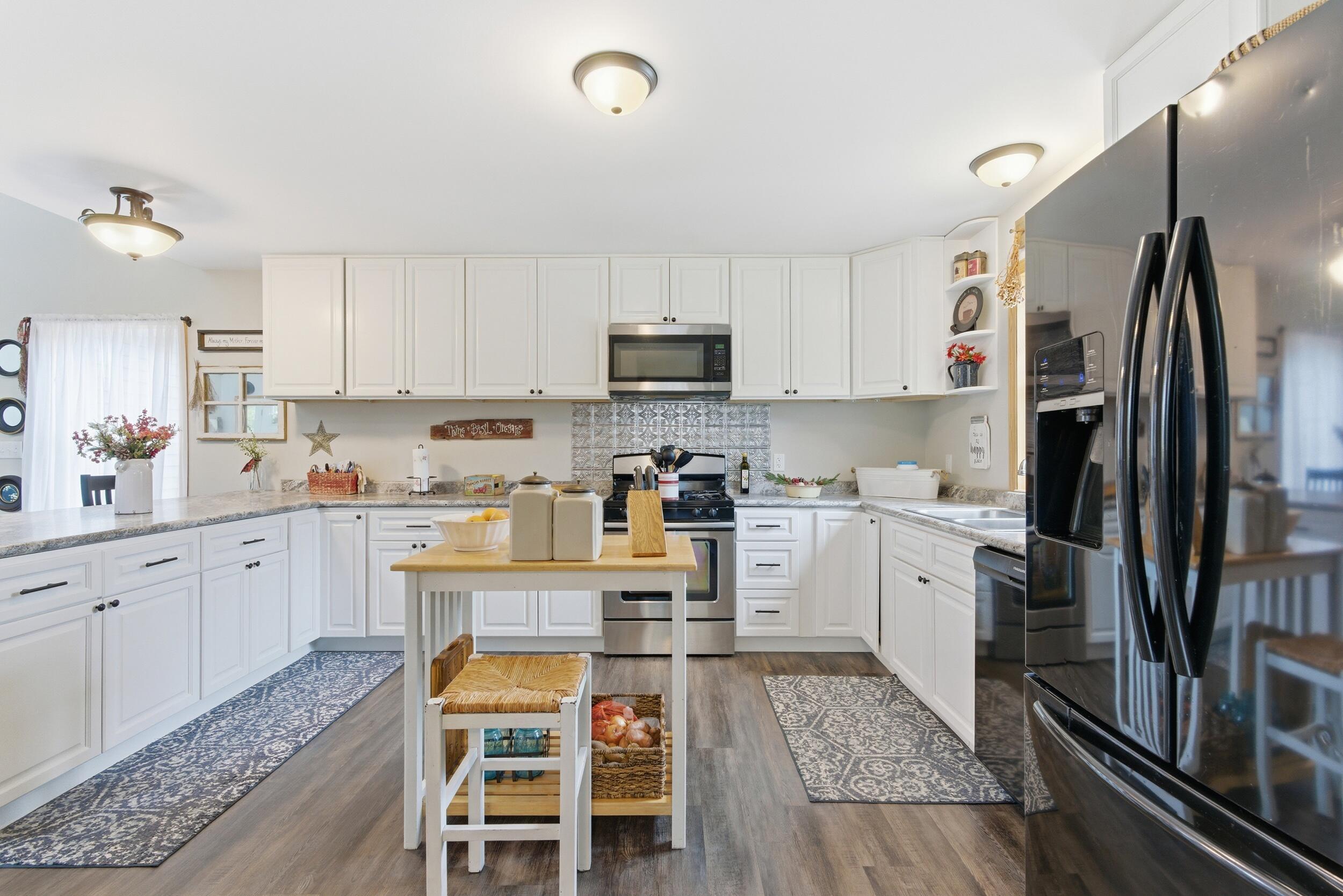 9960 Wildwood Place Demotte, IN 46310 - Photo 11 of 36 a kitchen with a refrigerator and microwave