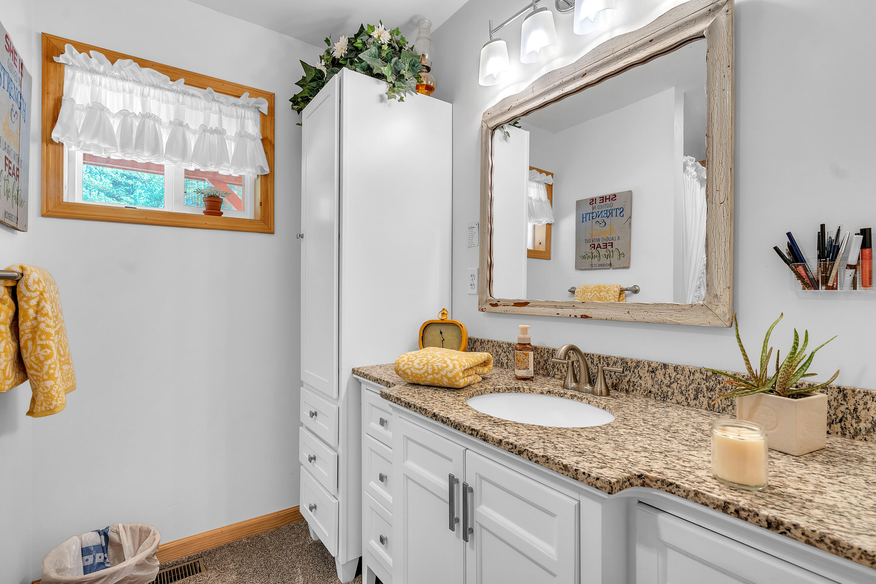 9960 Wildwood Place Demotte, IN 46310 - Photo 19 of 36 a bathroom with a granite countertop sink a large mirror and a window