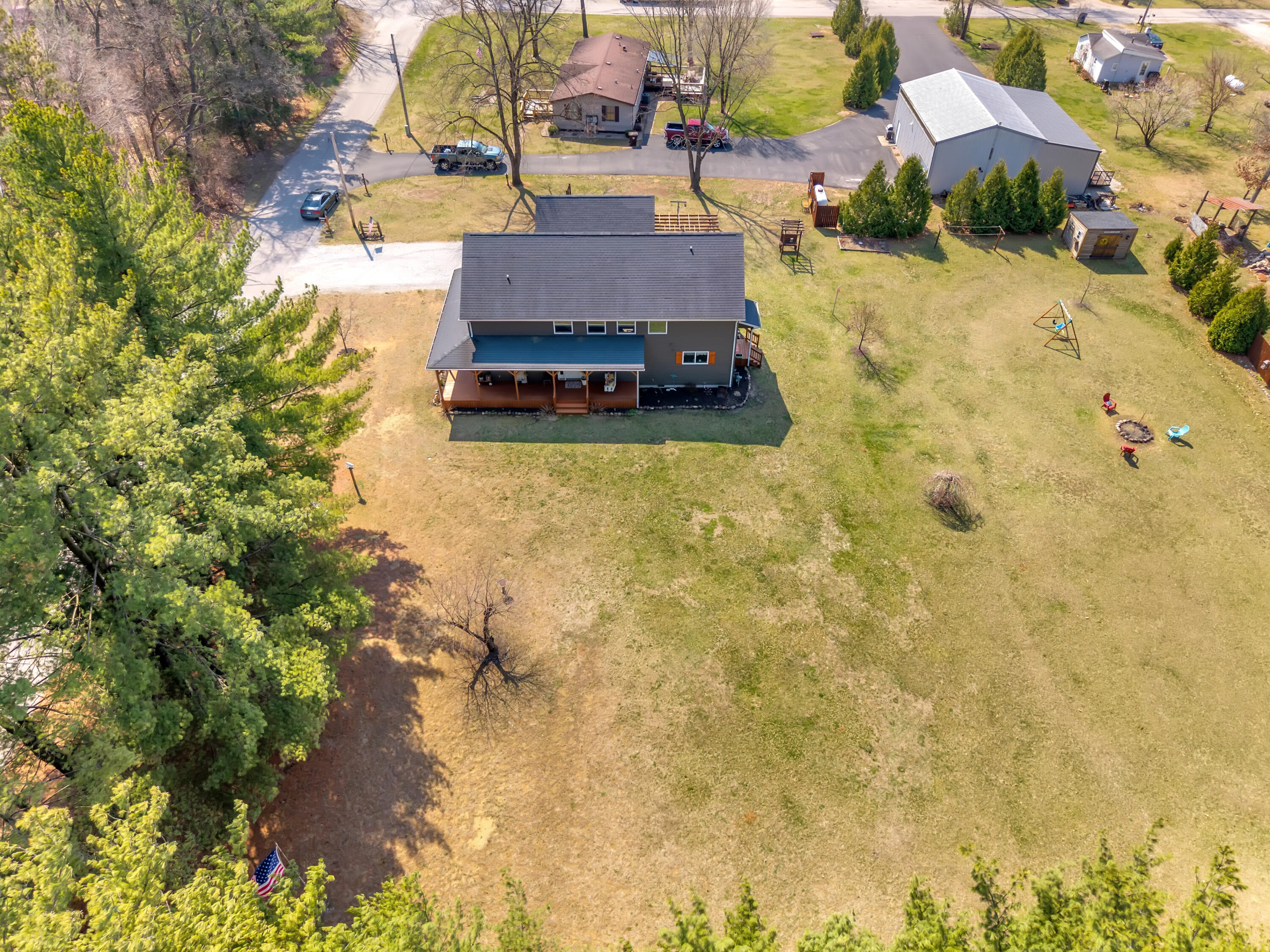 9960 Wildwood Place Demotte, IN 46310 - Photo 29 of 36 a aerial view of a house with swimming pool and large trees