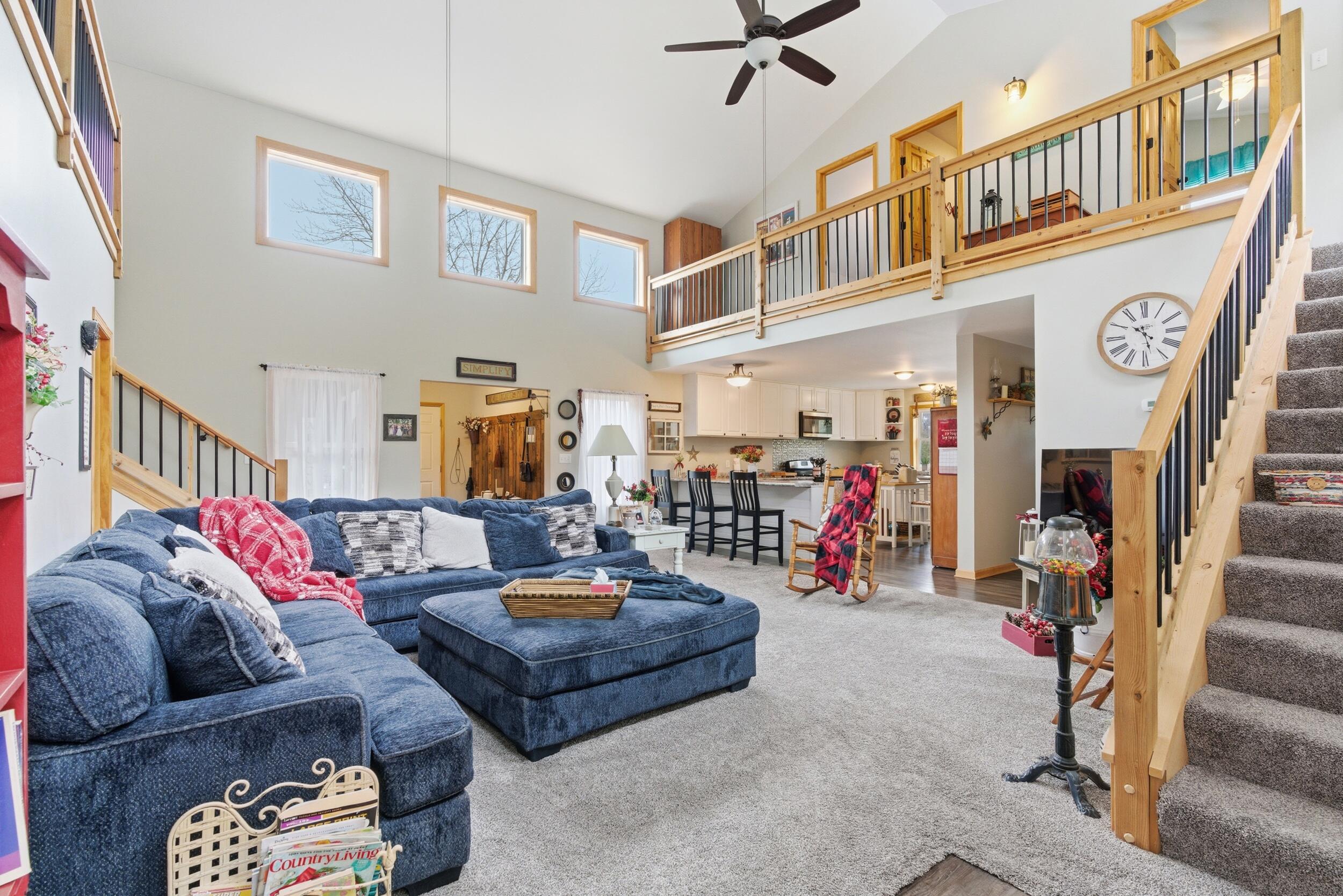 9960 Wildwood Place Demotte, IN 46310 - Photo 8 of 36 a living room with furniture a ceiling fan and a rug