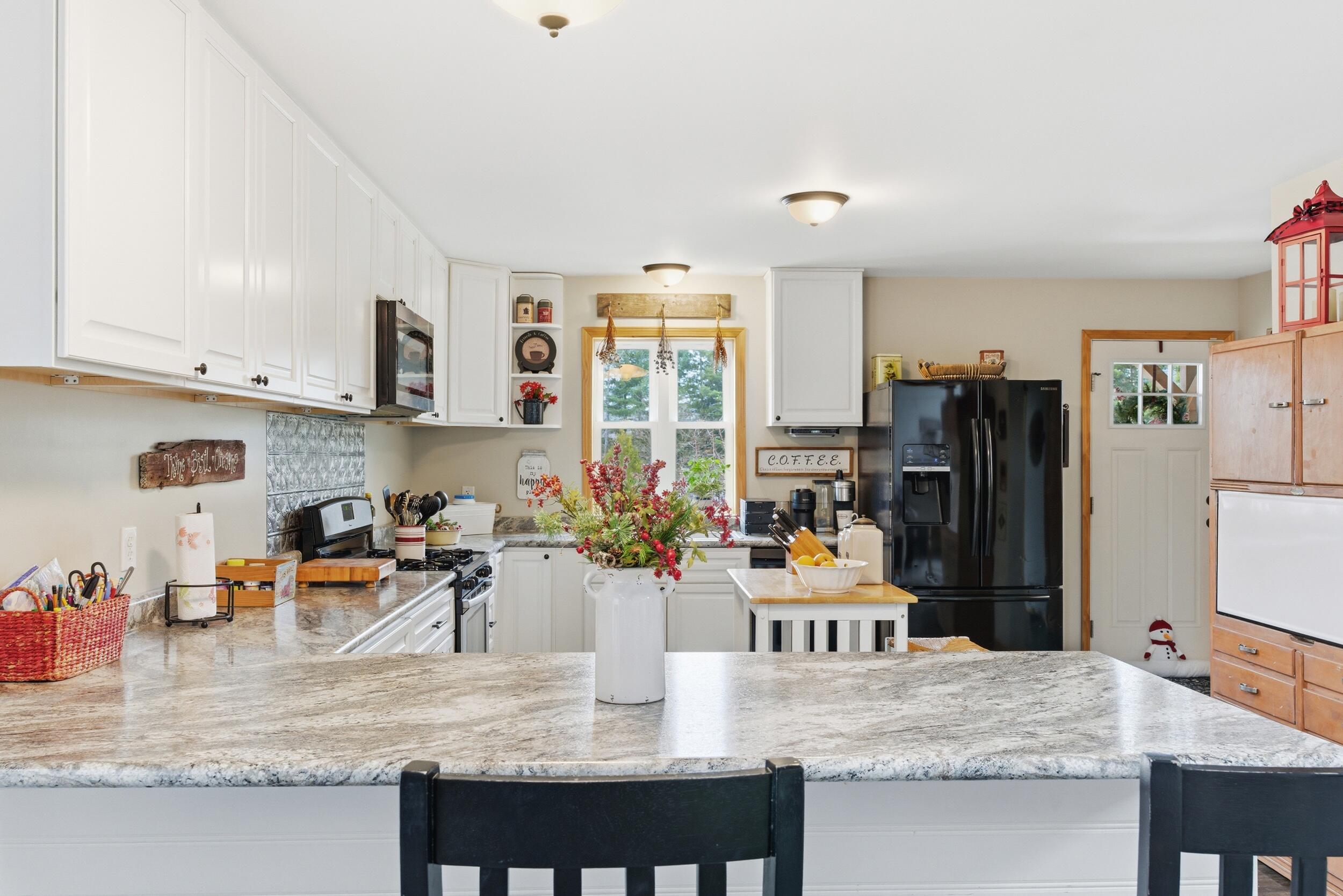 9960 Wildwood Place Demotte, IN 46310 - Photo 10 of 36 a kitchen with stainless steel appliances granite countertop a stove top oven a sink and cabinets