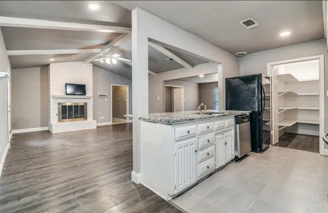 a view of a backyard with table and chairs and potted plants