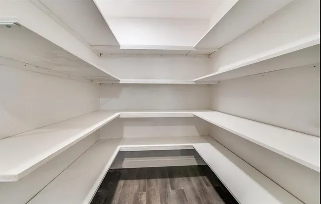 a kitchen with stainless steel appliances granite countertop a stove and a white cabinets