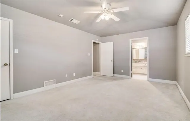 a bathroom with a granite countertop sink a toilet and a mirror