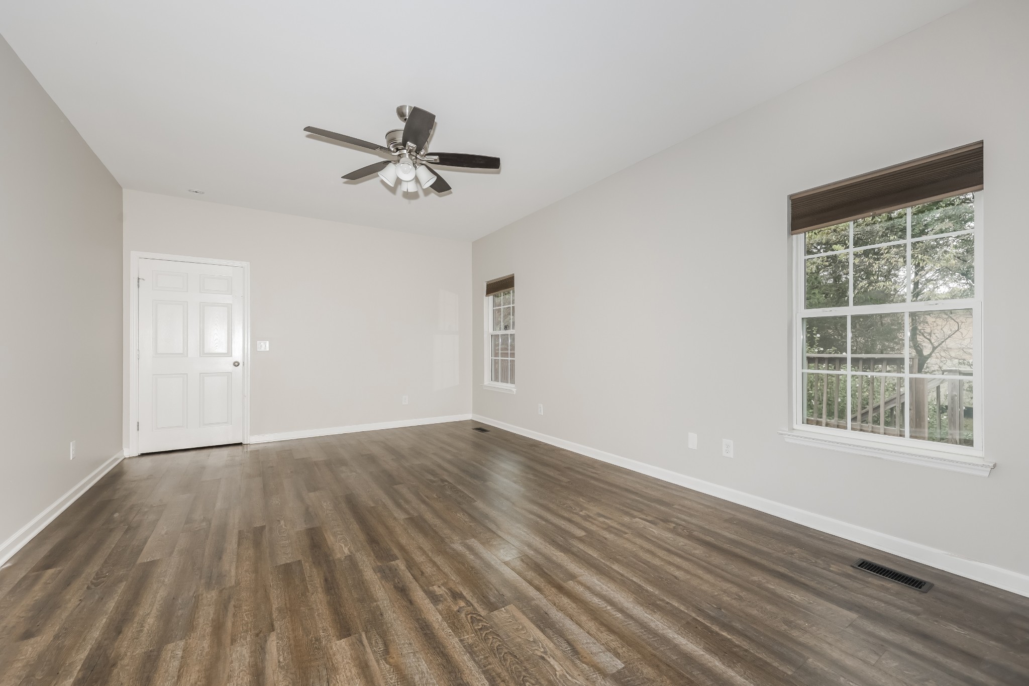 106 Abbey Road Lebanon, TN 37090 - Photo 8 of 17 an empty room with wooden floor ceiling fan and windows
