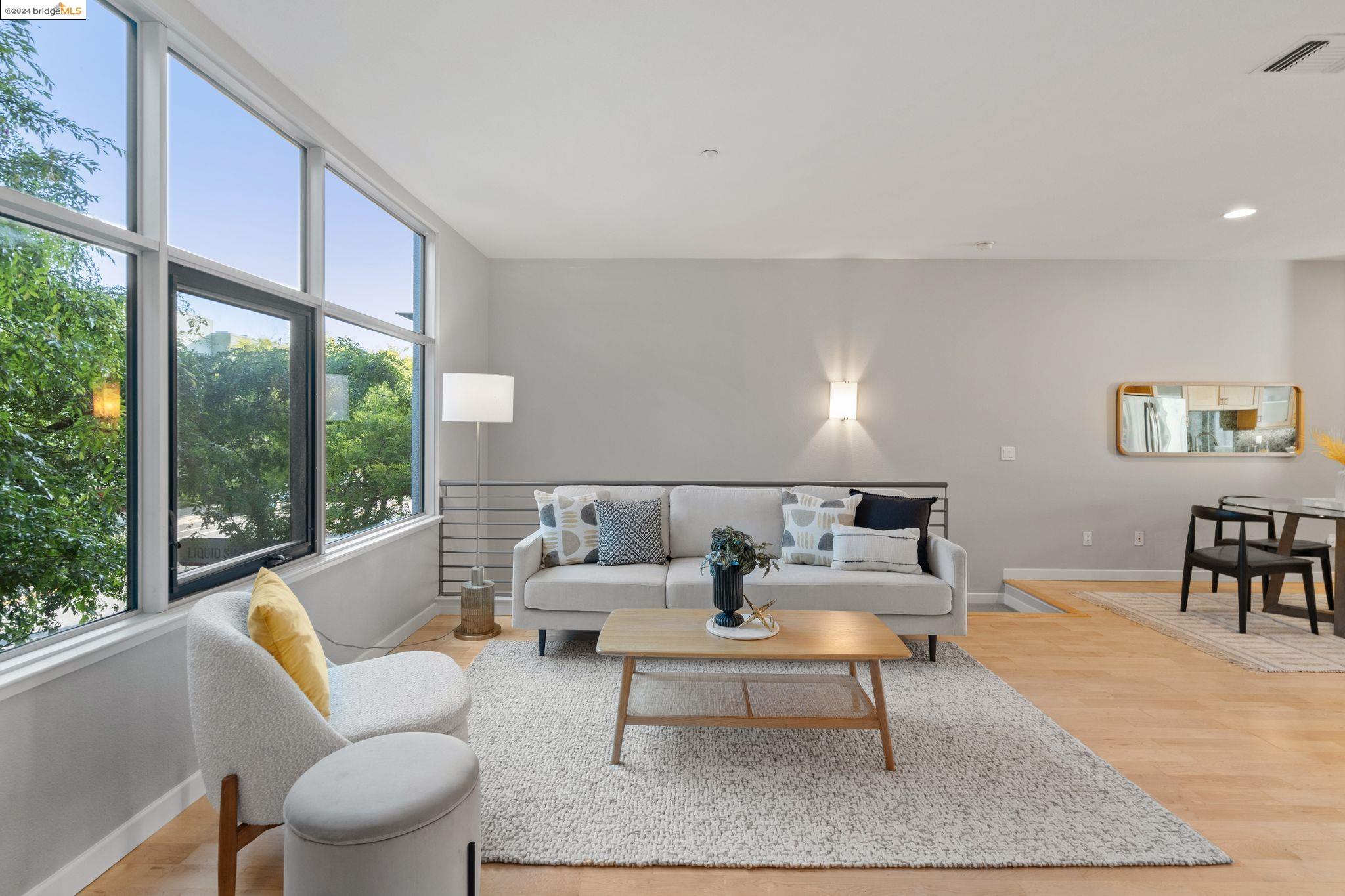 1248 65th Street Emeryville, CA 94608 - Photo 1 of 1 a living room with furniture and a large window