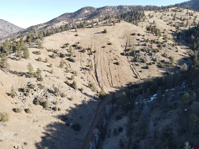 a view of a large mountain with a mountain in the background