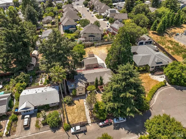 an aerial view of multiple houses with yard