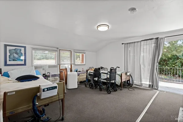 a bedroom with furniture and a large window