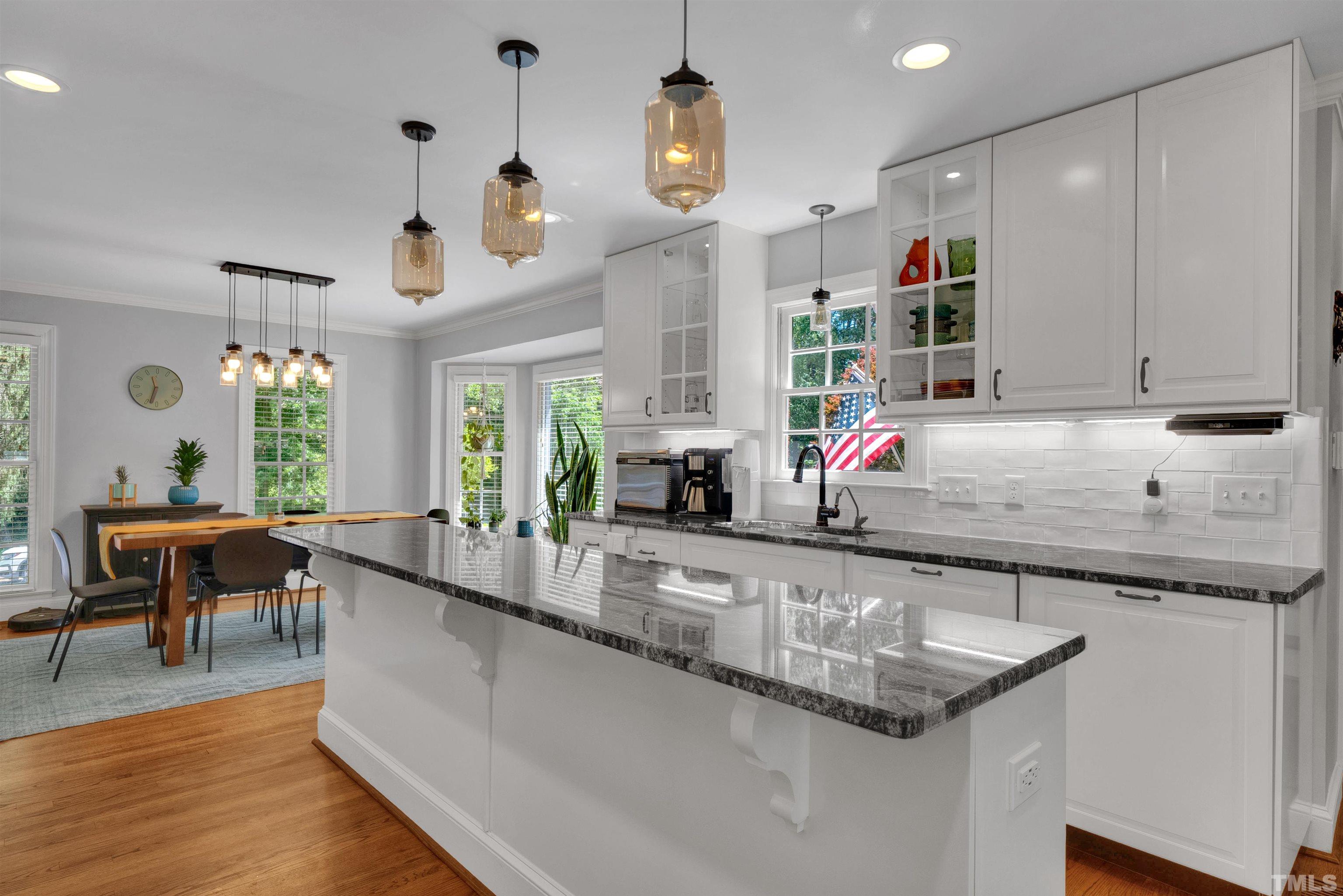 8209 Blue Heron Way Raleigh, NC 27615 - Photo 13 of 31 a kitchen with granite countertop a sink and a stove