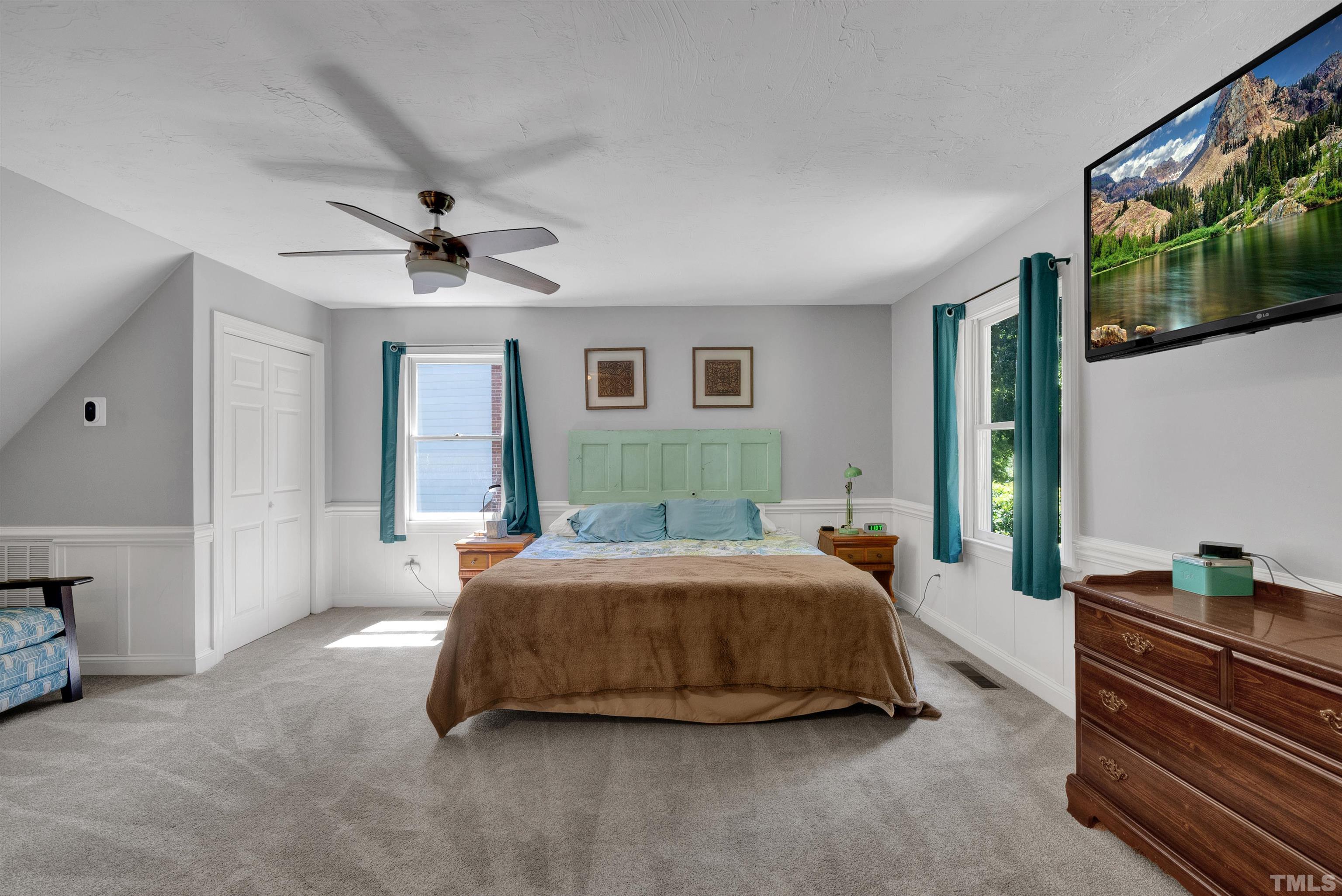 8209 Blue Heron Way Raleigh, NC 27615 - Photo 17 of 31 a spacious bedroom with a bed and a walk in closet