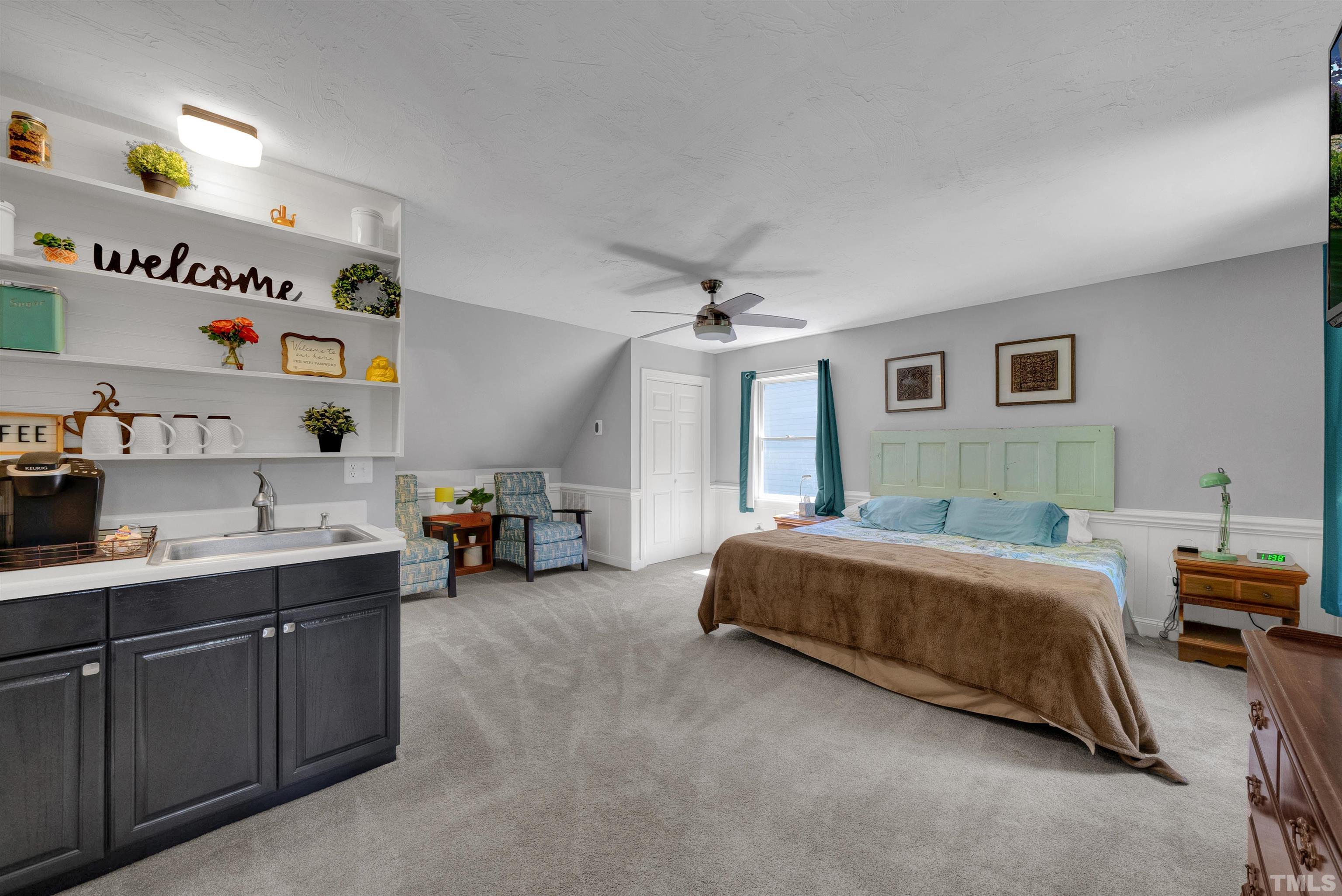 8209 Blue Heron Way Raleigh, NC 27615 - Photo 19 of 31 a spacious bedroom with a bed and a cabinets
