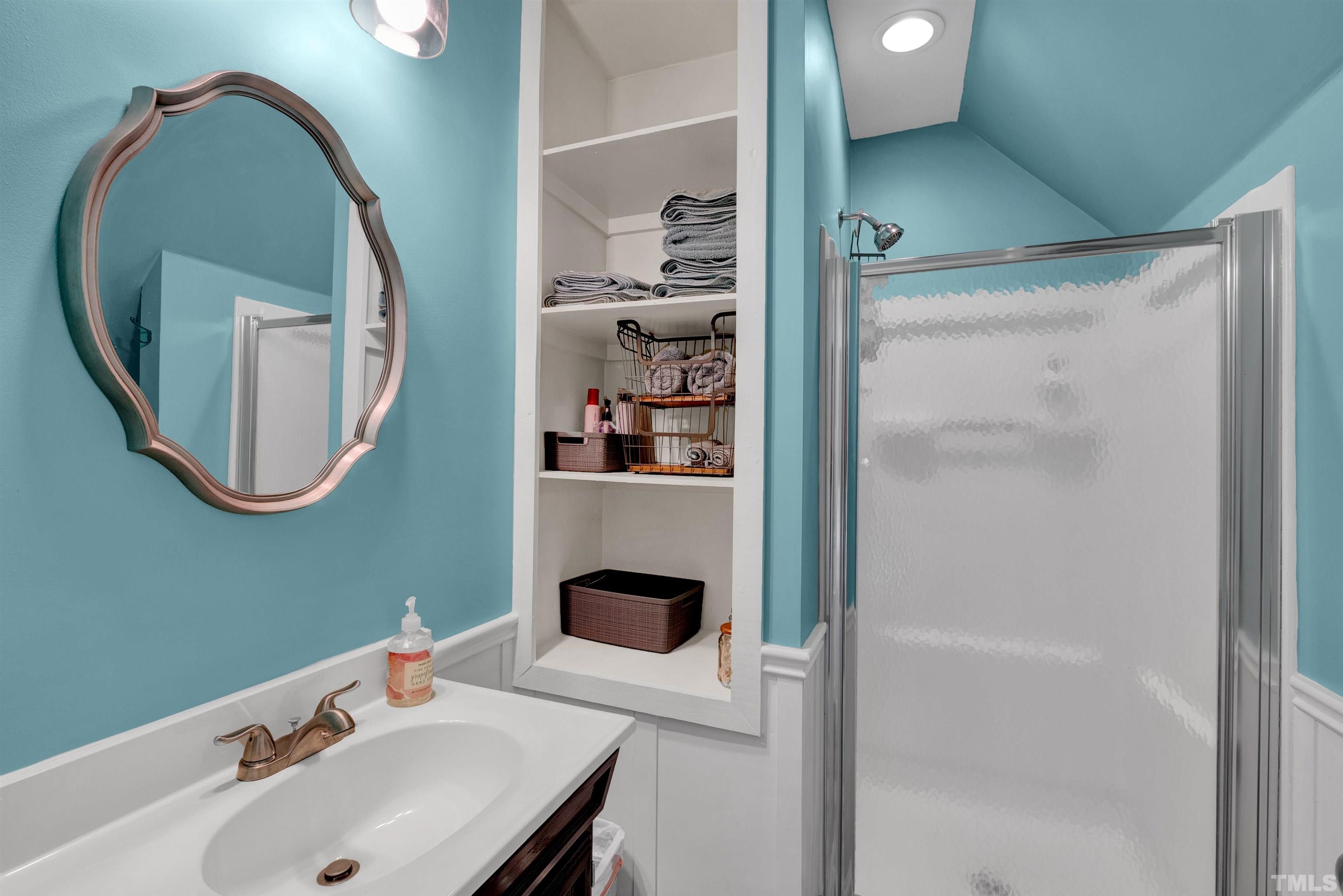 8209 Blue Heron Way Raleigh, NC 27615 - Photo 20 of 31 a bathroom with a sink a vanity and a mirror