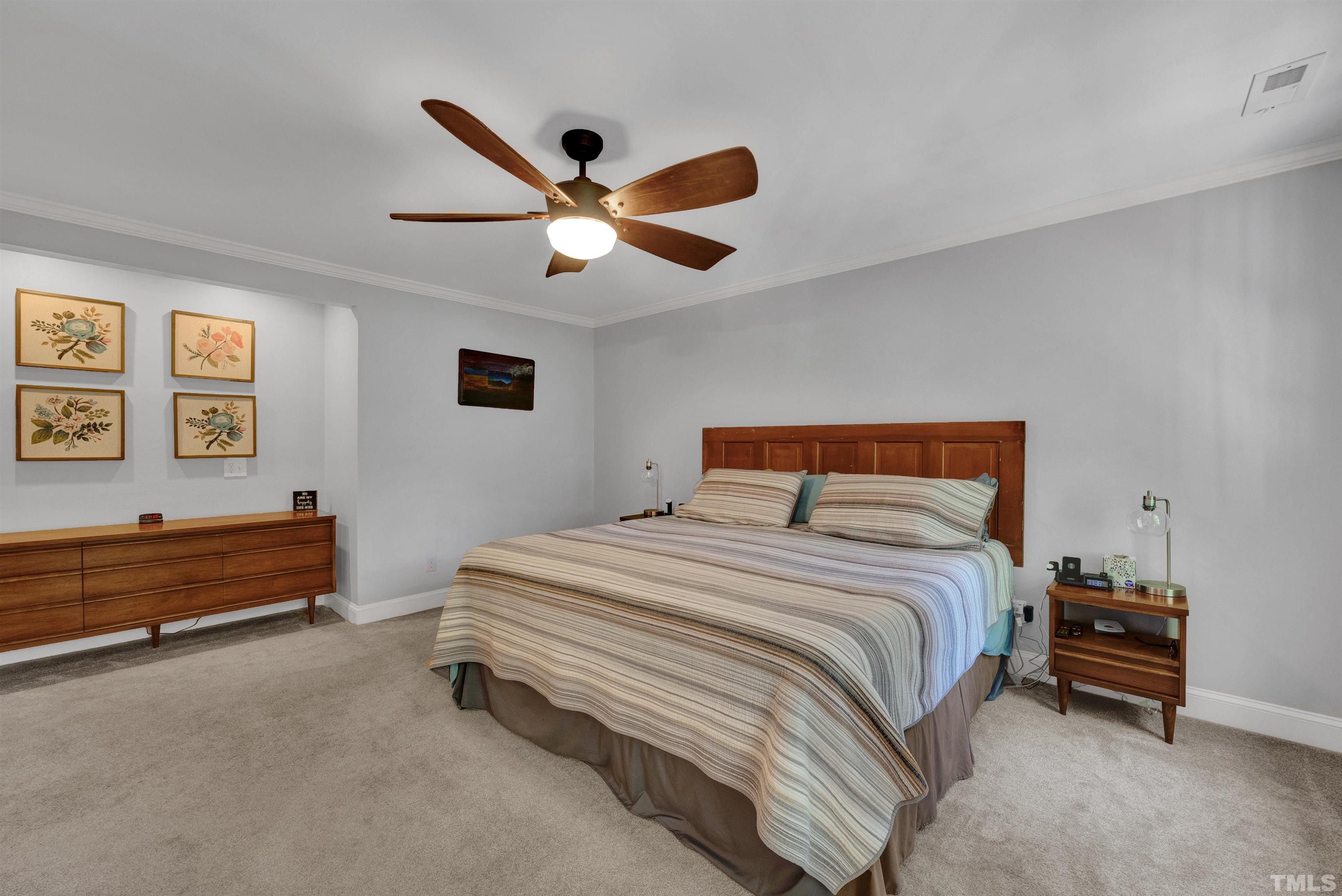 8209 Blue Heron Way Raleigh, NC 27615 - Photo 21 of 31 a bedroom with a bed and a ceiling fan