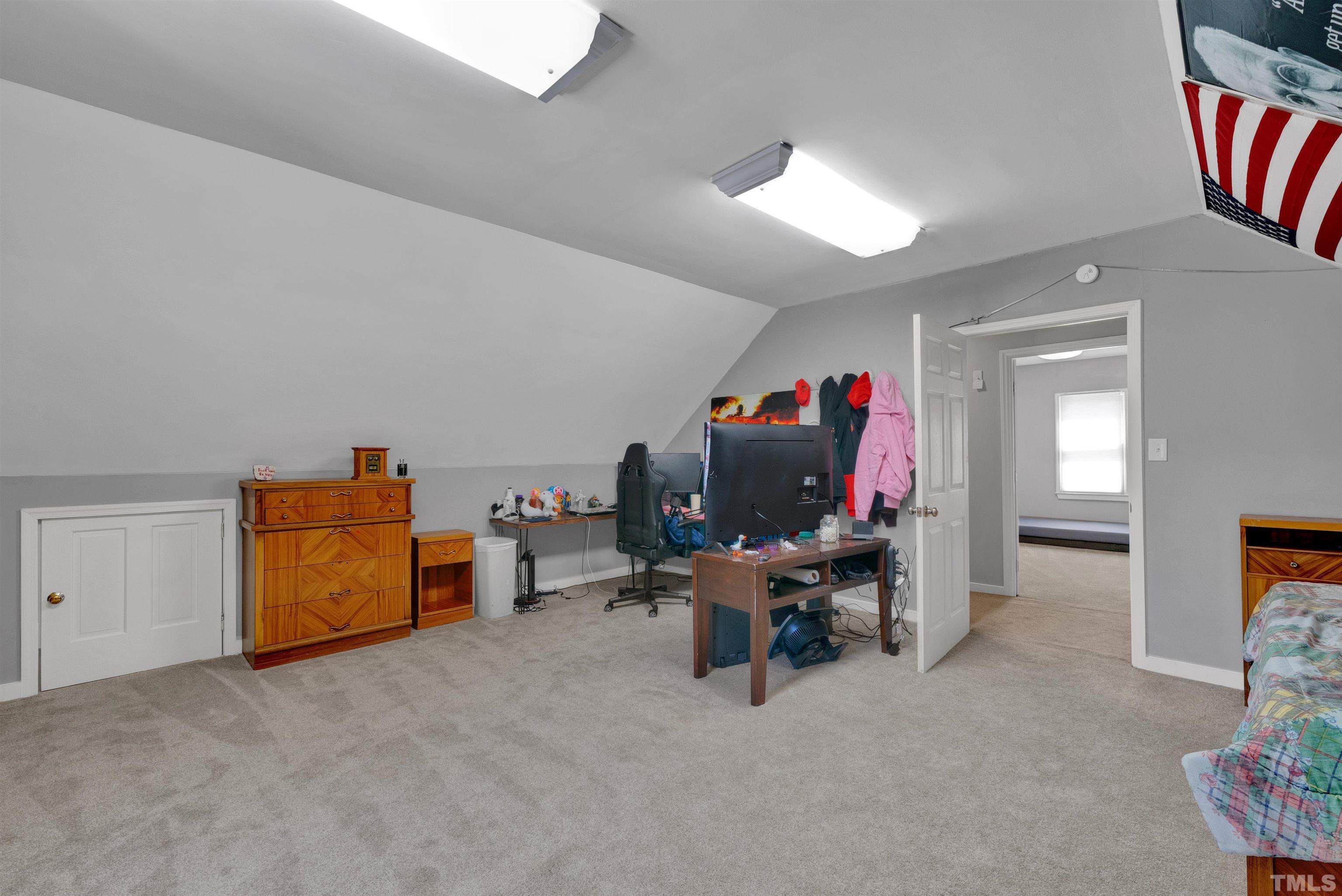 8209 Blue Heron Way Raleigh, NC 27615 - Photo 26 of 31 a view of a workspace with furniture and a flat screen tv