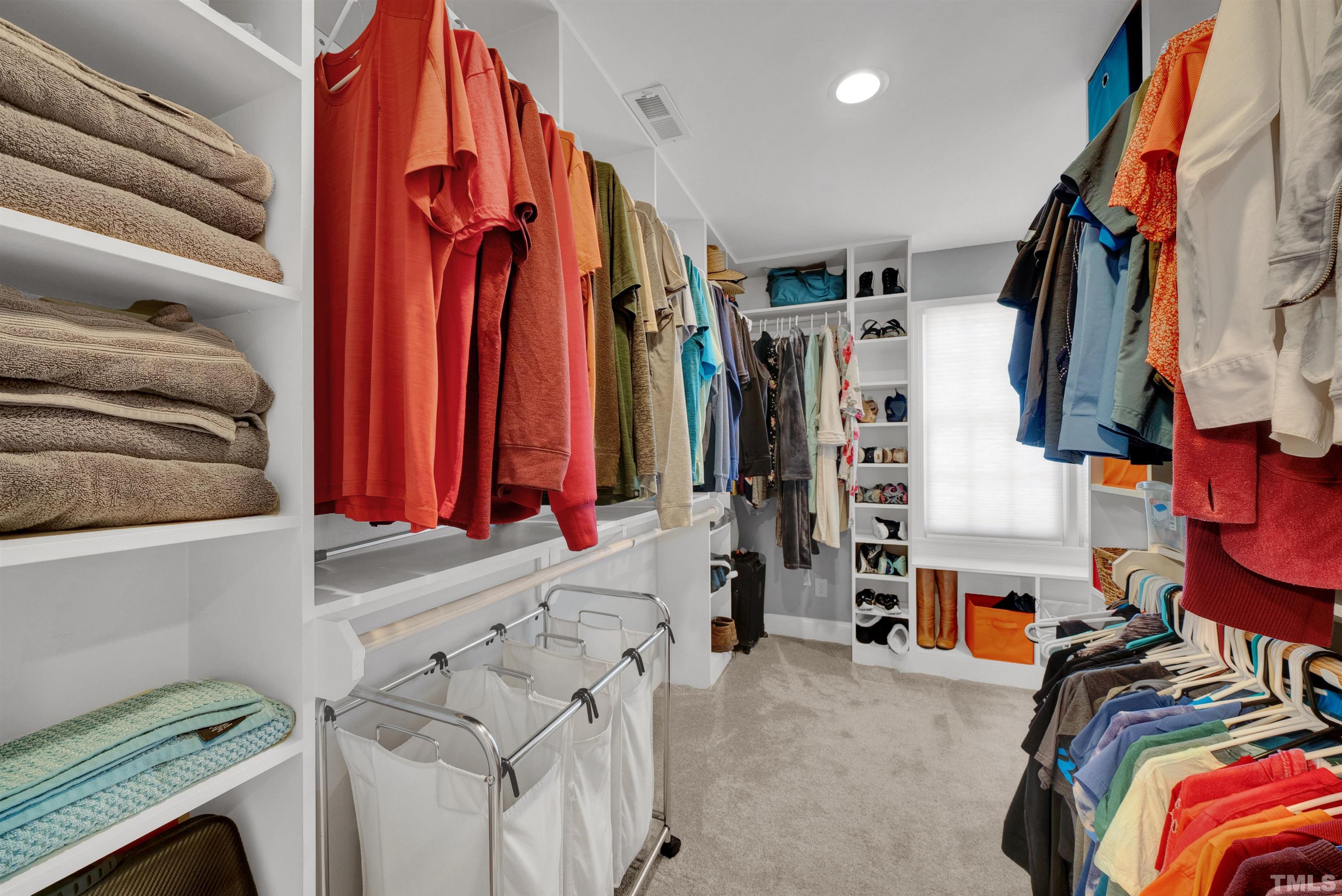 8209 Blue Heron Way Raleigh, NC 27615 - Photo 30 of 31 a view of walk in closet with clothes and shoes
