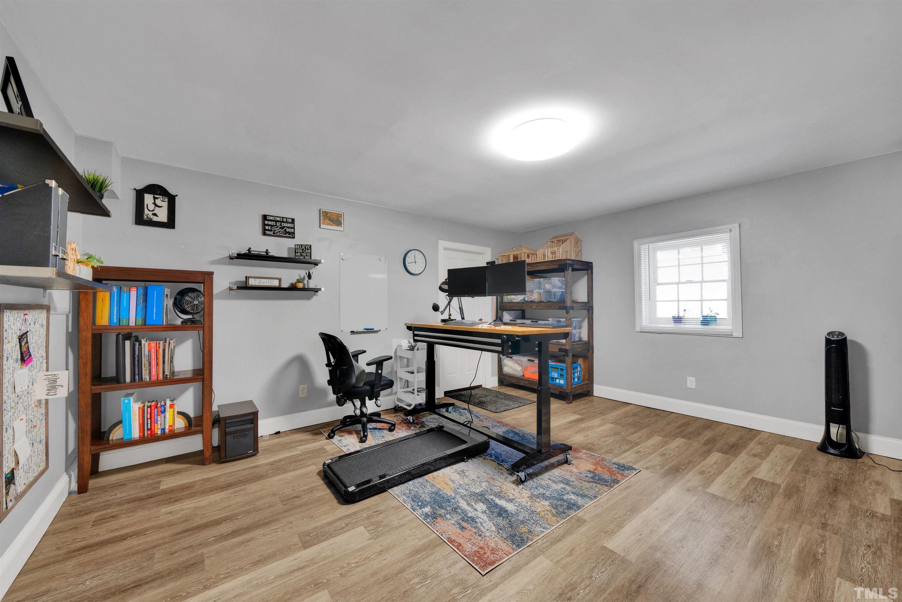 8209 Blue Heron Way Raleigh, NC 27615 - Photo 31 of 31 a view of a workspace with furniture and a bookshelf