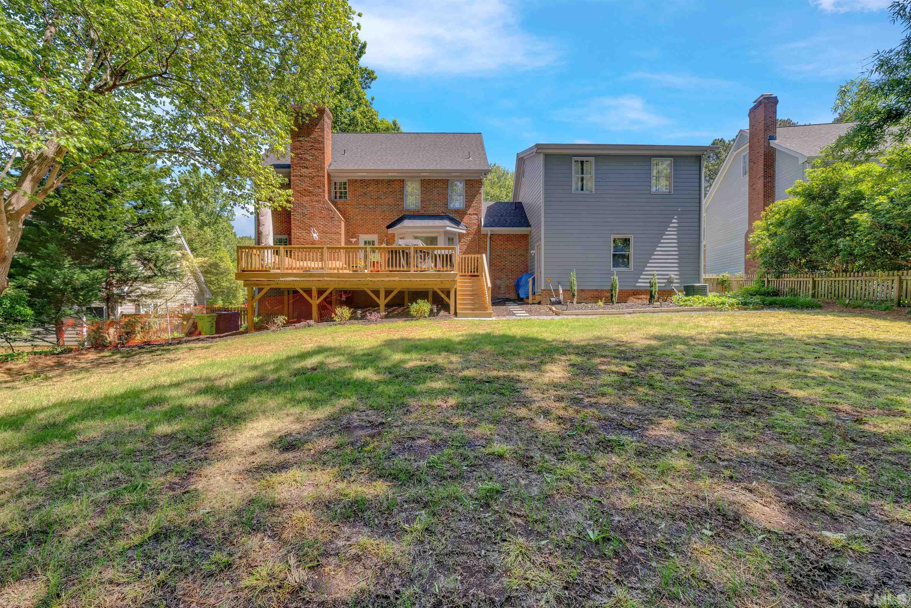 8209 Blue Heron Way Raleigh, NC 27615 - Photo 5 of 31 a view of a house with a big yard and large trees