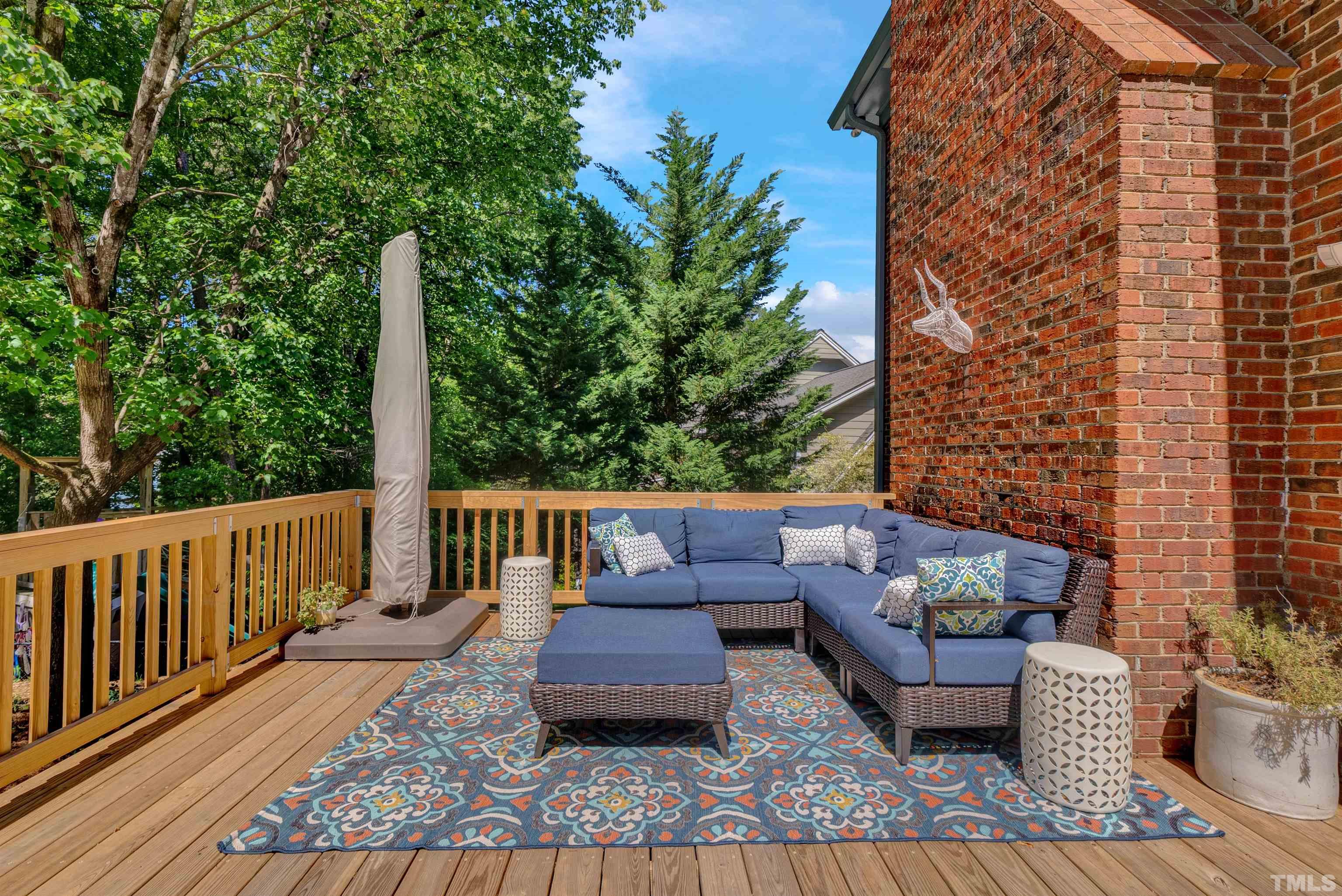 8209 Blue Heron Way Raleigh, NC 27615 - Photo 7 of 31 a balcony with wooden floor and outdoor seating