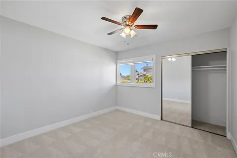 a view of a hallway with a ceiling fan