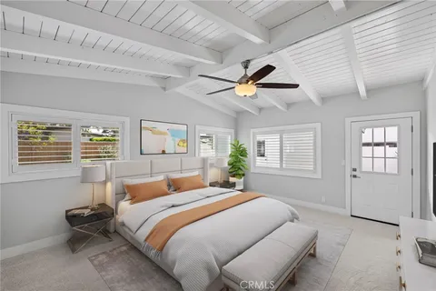 a bedroom with a large bed and a window