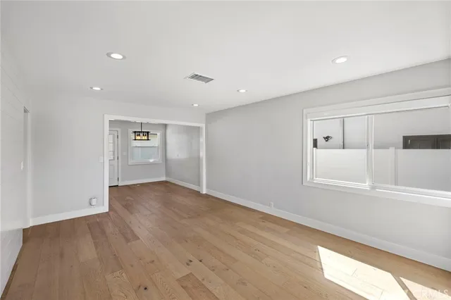 wooden floor in an empty room with a window
