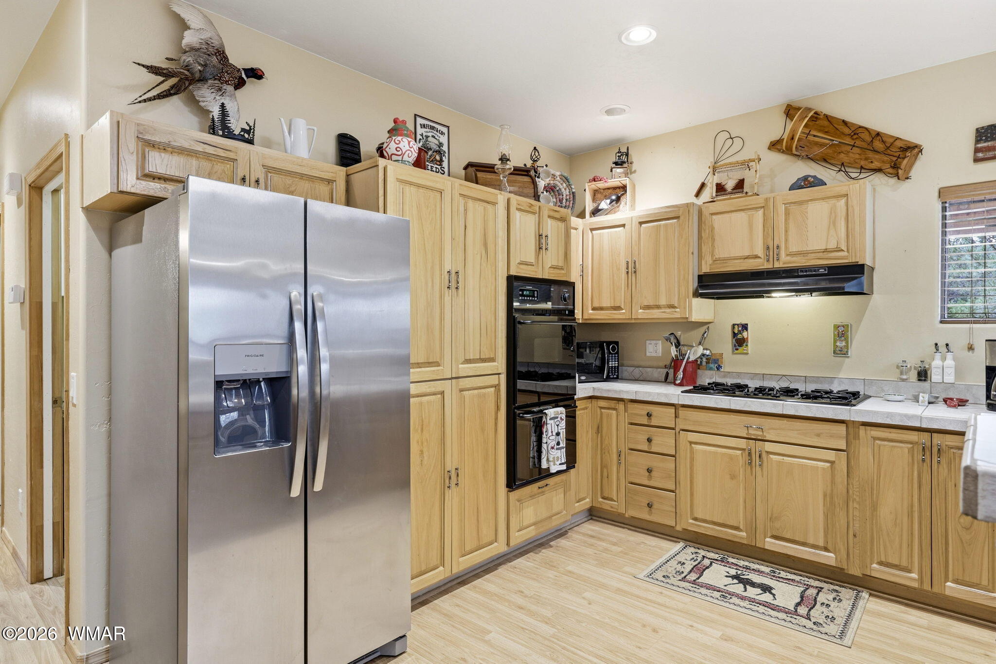 2008 Lexington Overgaard, AZ 85933 - Photo 12 of 34 a kitchen with stainless steel appliances granite countertop a refrigerator a sink and white cabinets