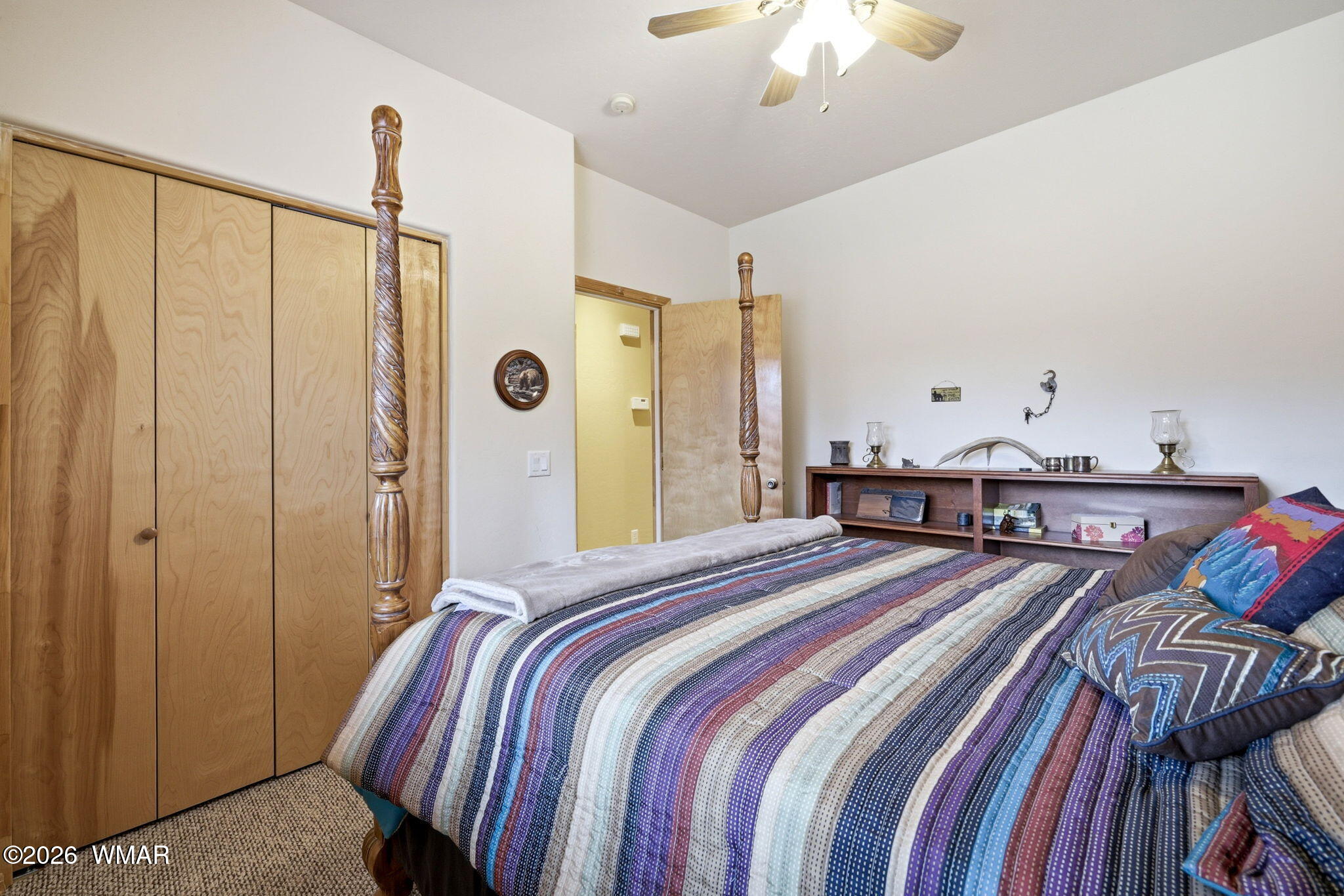 2008 Lexington Overgaard, AZ 85933 - Photo 15 of 34 a bedroom with a bed and a chandelier