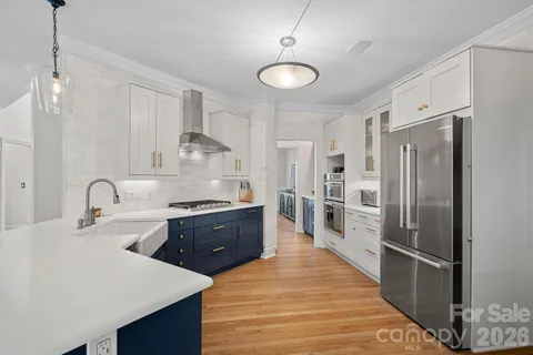 a large kitchen with stainless steel appliances a stove refrigerator a sink and dishwasher