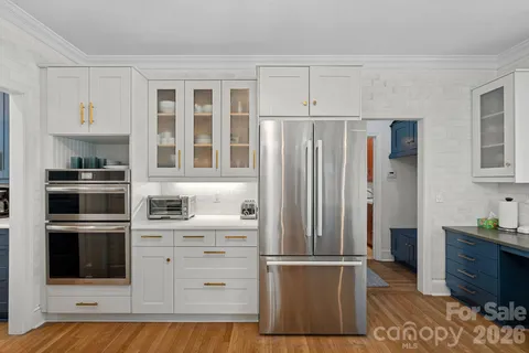 a kitchen with stainless steel appliances a refrigerator and cabinets