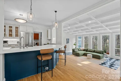 a living room with furniture a wooden floor and chandelier