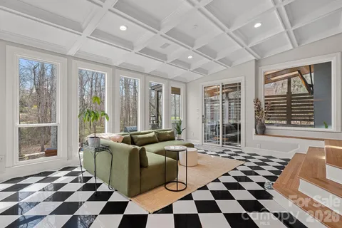 a living room with furniture and a floor to ceiling window