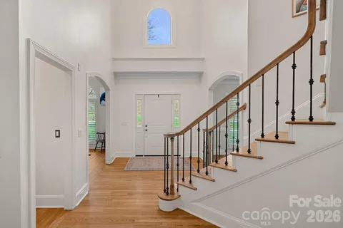 a view of staircase with railing and white walls