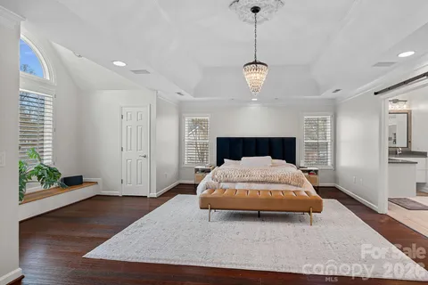 a spacious bedroom with a bed and a large window