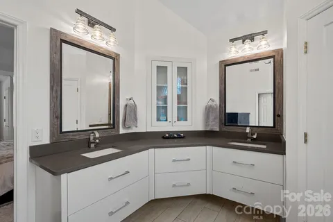 a bathroom with double sink and a mirror