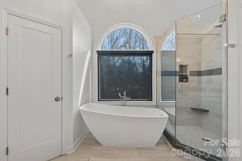 a bathroom with a bathtub and shower