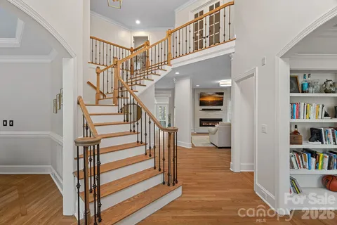 a view of entryway and hall with wooden floor