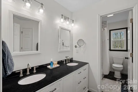 a bathroom with a double vanity sink and a mirror