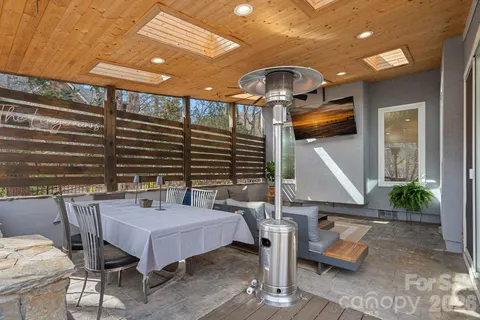 a roof deck with table and chairs