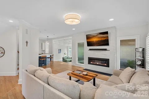 a living room with furniture flat screen tv and a fireplace