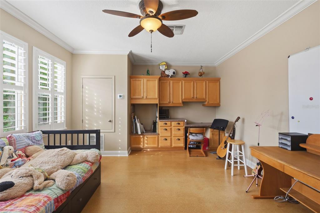 907 Pawstand Road Celebration, FL 34747 - Photo 25 of 49 a bedroom with furniture and a chandelier